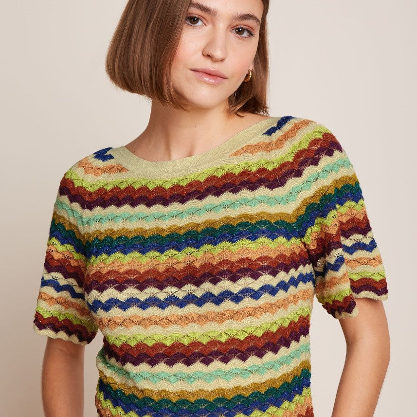 Woman wearing a colorful striped top from king louie clothing